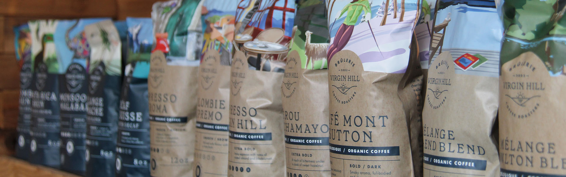 Row of coffee bags with various labels and designs.
