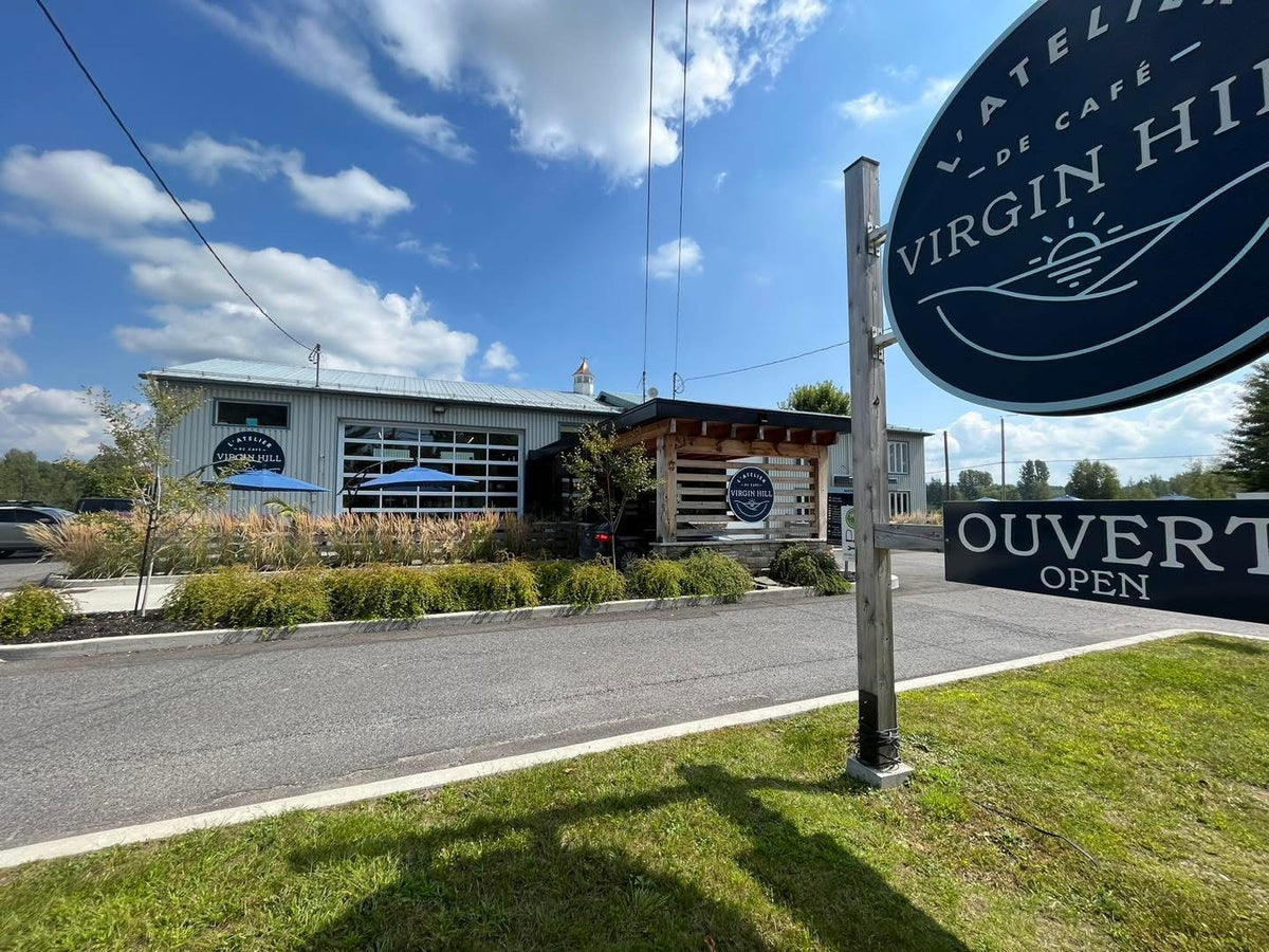 Restaurant exterior with 'Virgin Hill' sign and blue sky