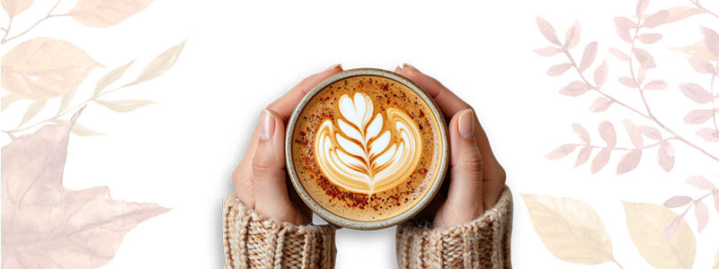 Someone holding a pumpkin spice latte