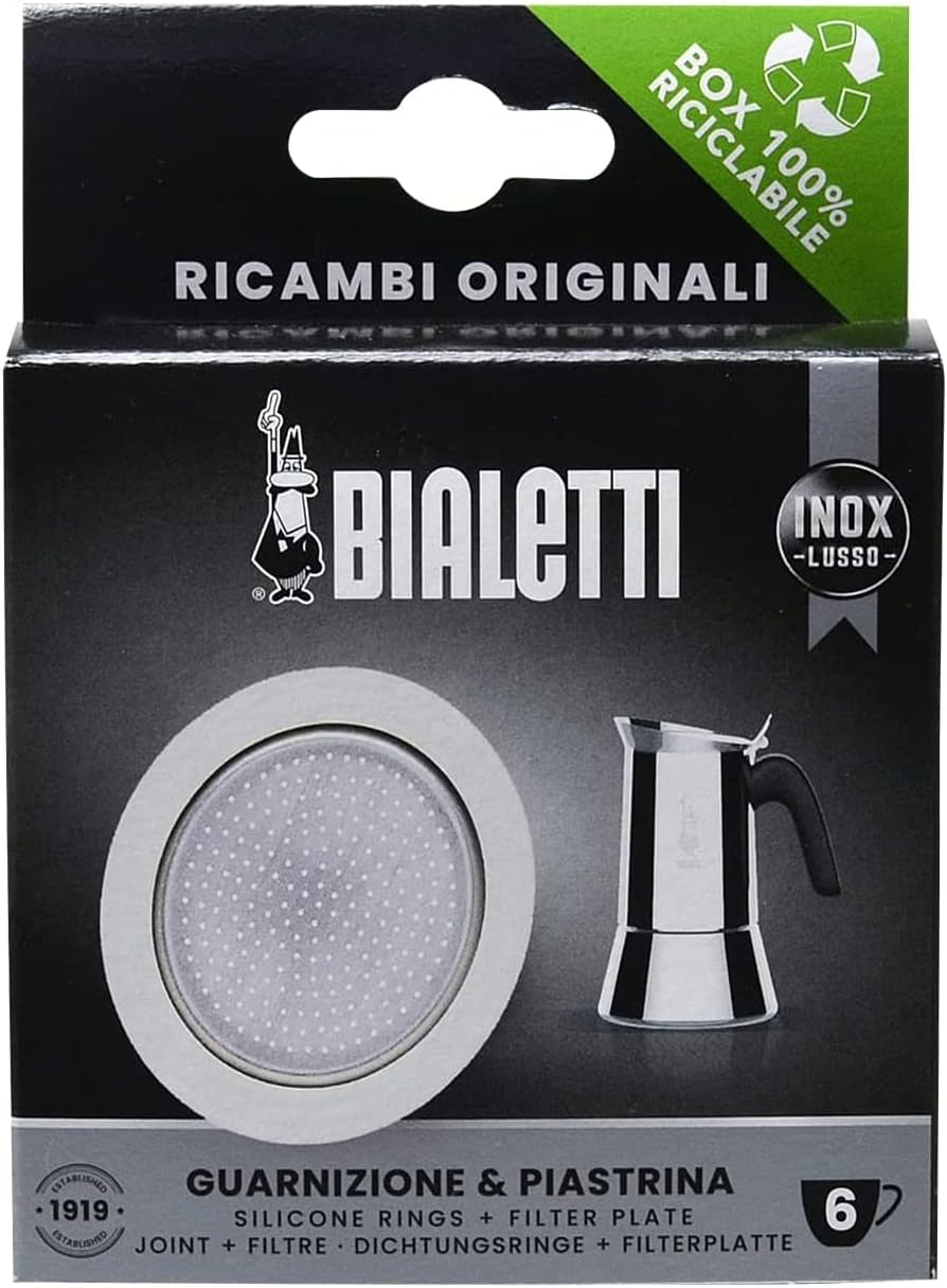 Bialetti coffee maker parts packaging with silicone ring and filter plate on a black background