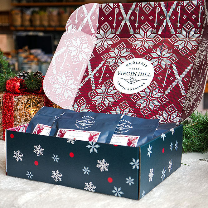 Christmas-themed gift set with branded box and decorative elements on a table.