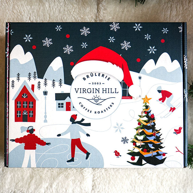 Christmas-themed product packaging with snowy landscape and festive elements on a textured surface.