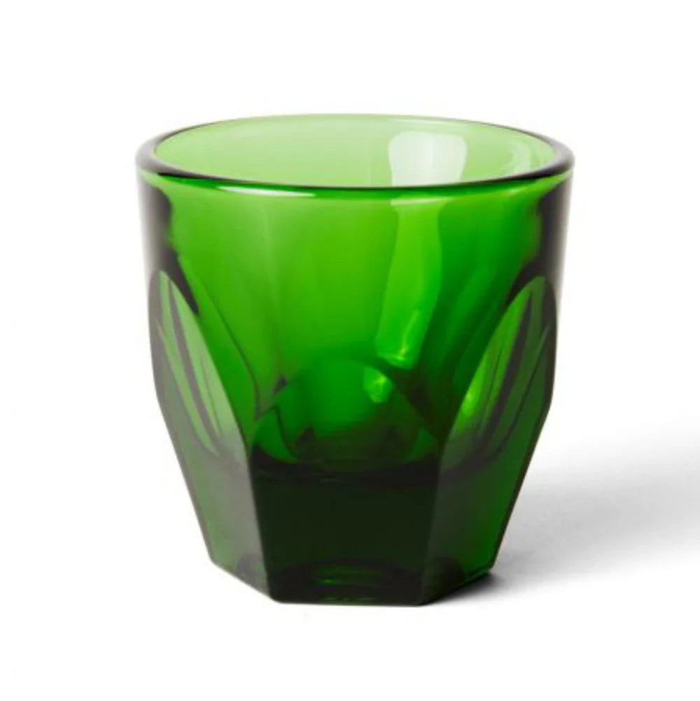 Green glass tumbler on a white background